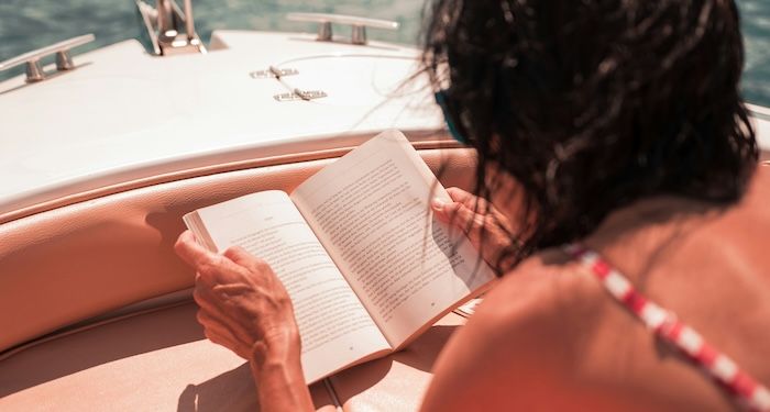 woman reading on boat.jpg.optimal