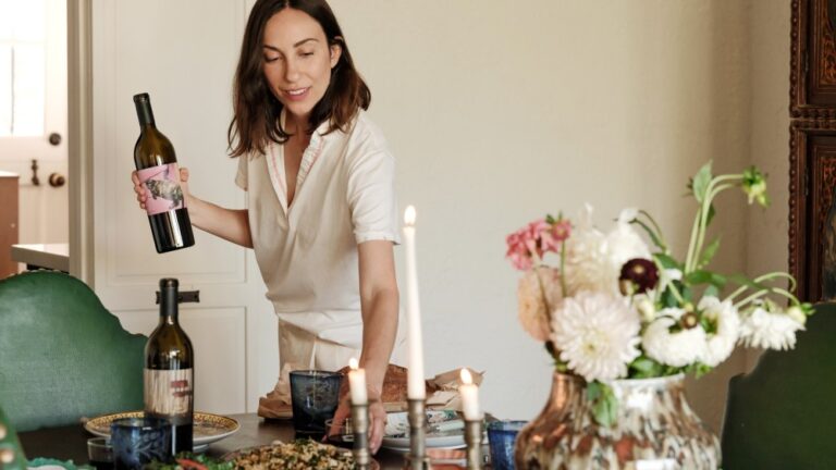 Gia Coppola Holding the Red Blend at Indoor Tablescape credit Bliss Braoudakis