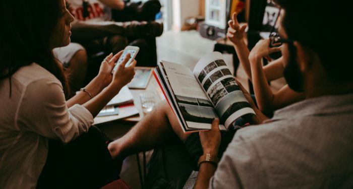 people gathered in a circle with books talking to each other.jpg.optimal