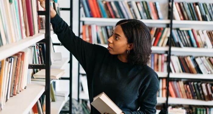librarian shelving books in a library for libraries feature 700x375 1.jpg.optimal